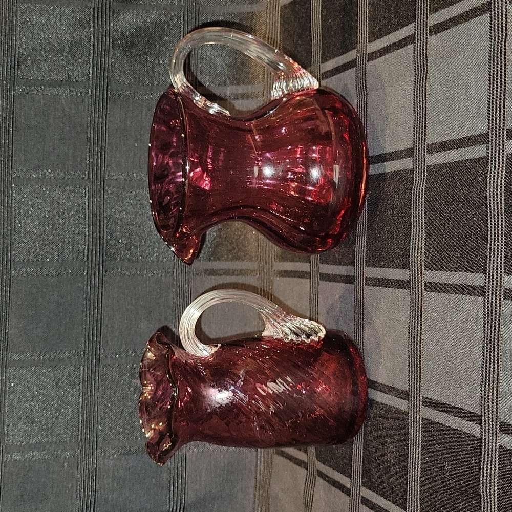 Two small Cranberry pitchers